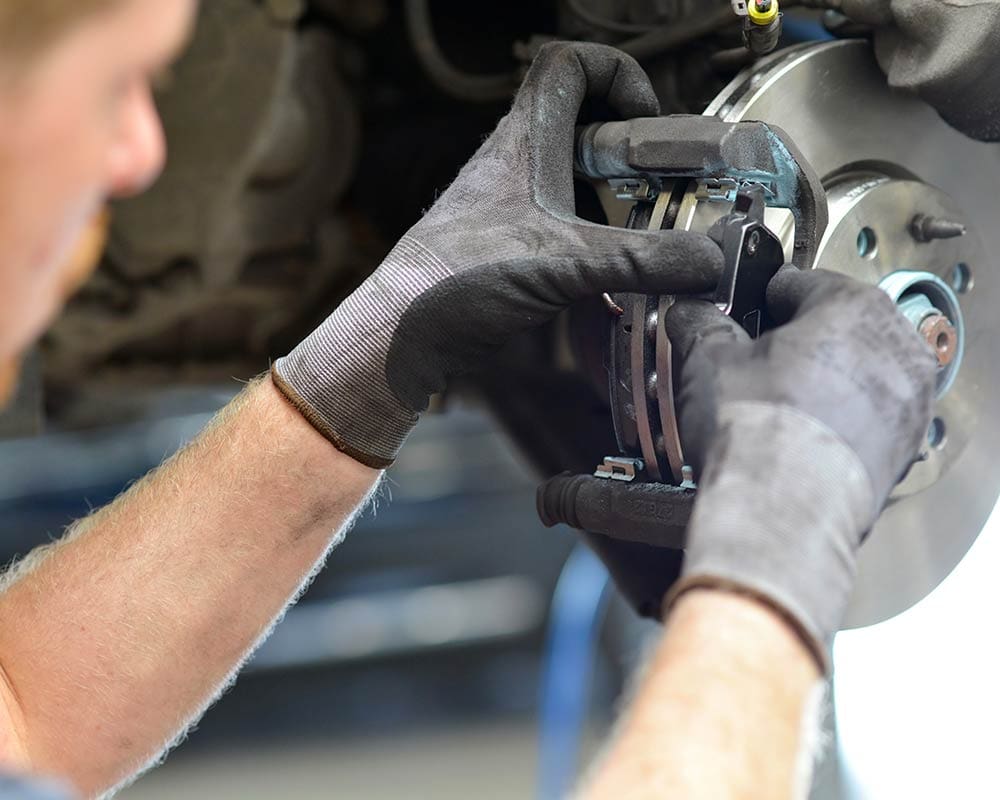 Grease Monkey technician performing a brake service.